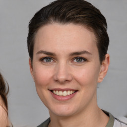 Joyful white young-adult female with short  brown hair and grey eyes