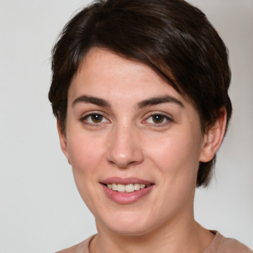 Joyful white young-adult female with medium  brown hair and brown eyes