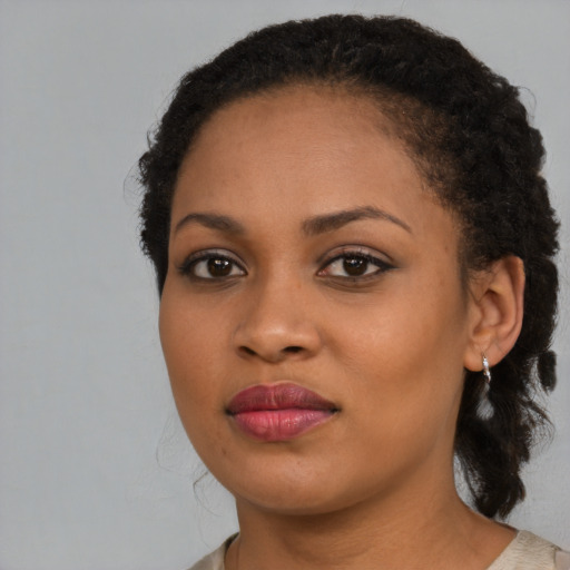 Joyful black young-adult female with medium  brown hair and brown eyes