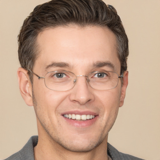 Joyful white adult male with short  brown hair and brown eyes