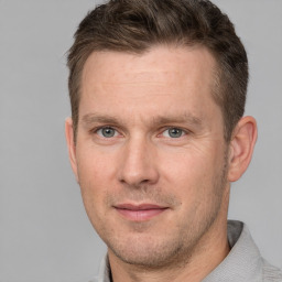 Joyful white adult male with short  brown hair and grey eyes