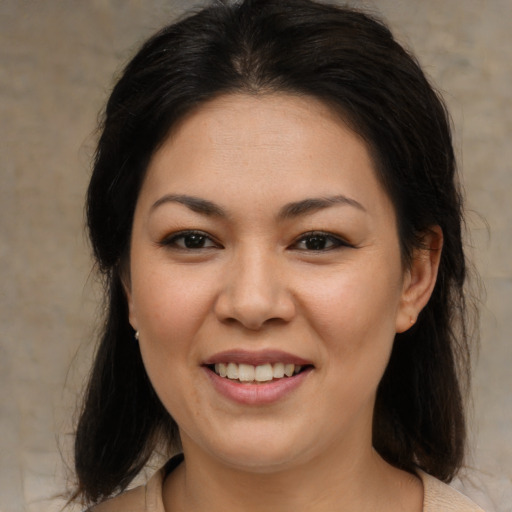 Joyful asian young-adult female with medium  brown hair and brown eyes