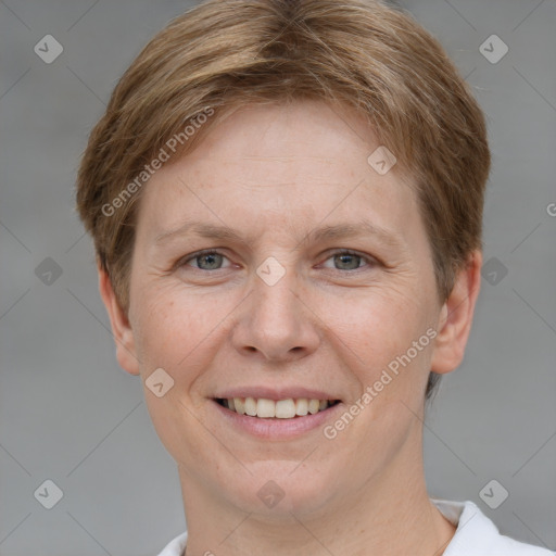 Joyful white adult female with short  brown hair and grey eyes