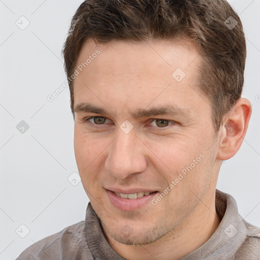 Joyful white adult male with short  brown hair and brown eyes