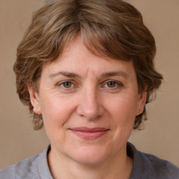 Joyful white adult female with medium  brown hair and grey eyes