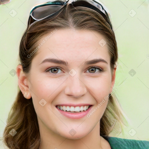 Joyful white young-adult female with long  brown hair and green eyes