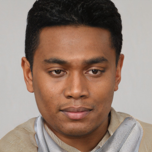 Joyful black young-adult male with short  black hair and brown eyes