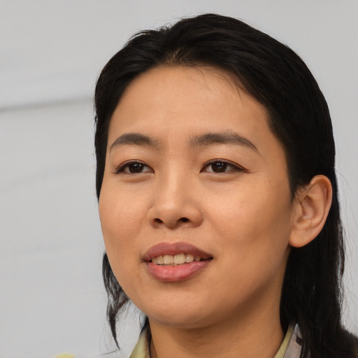 Joyful asian young-adult female with medium  black hair and brown eyes