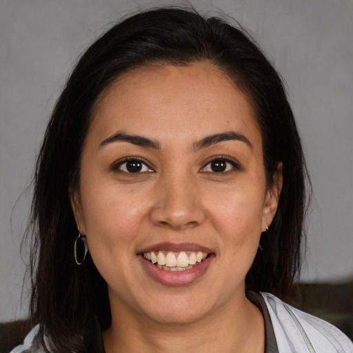 Joyful white young-adult female with medium  brown hair and brown eyes