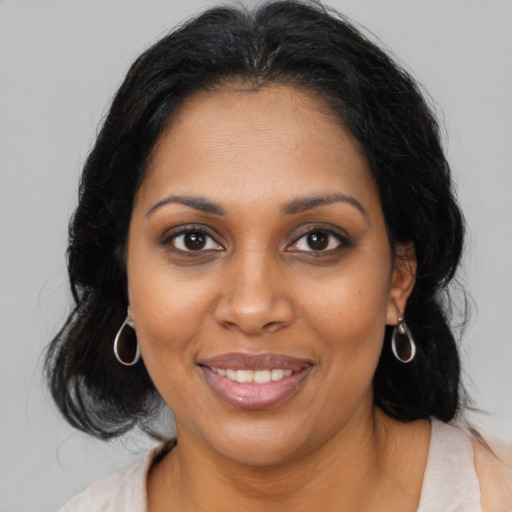 Joyful black young-adult female with medium  brown hair and brown eyes