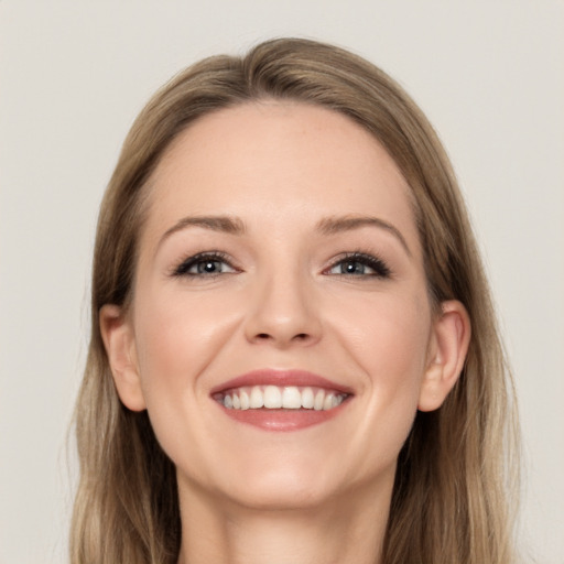 Joyful white young-adult female with long  brown hair and grey eyes