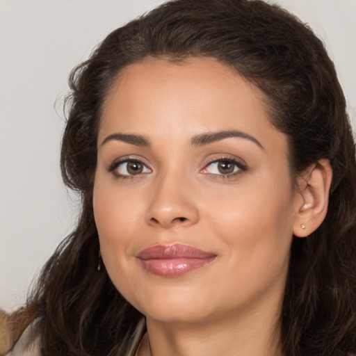 Joyful white young-adult female with long  brown hair and brown eyes