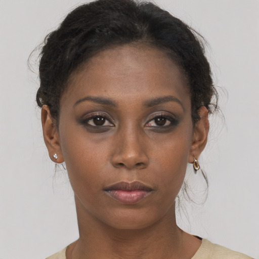Neutral black young-adult female with medium  brown hair and brown eyes