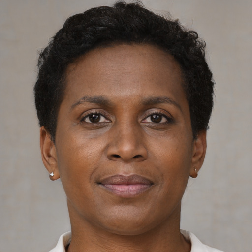 Joyful black adult female with short  brown hair and brown eyes