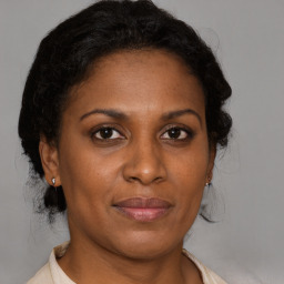 Joyful black adult female with medium  brown hair and brown eyes