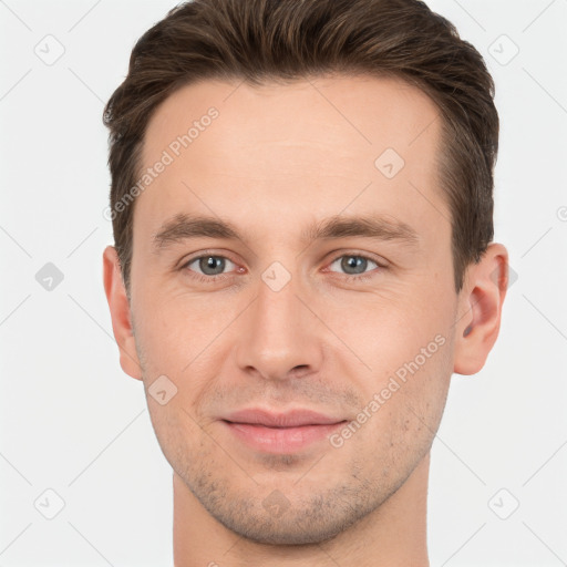 Joyful white young-adult male with short  brown hair and brown eyes