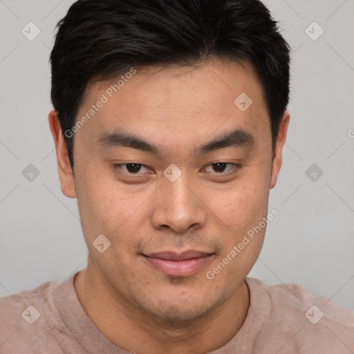 Joyful asian young-adult male with short  brown hair and brown eyes