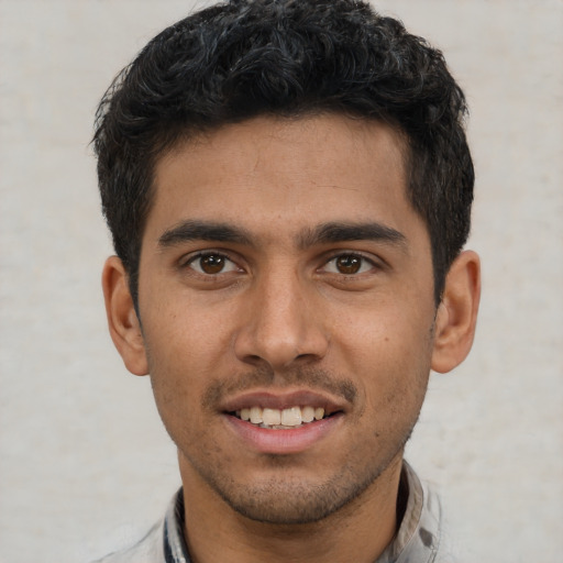 Joyful white young-adult male with short  black hair and brown eyes