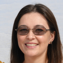 Joyful white adult female with long  brown hair and brown eyes