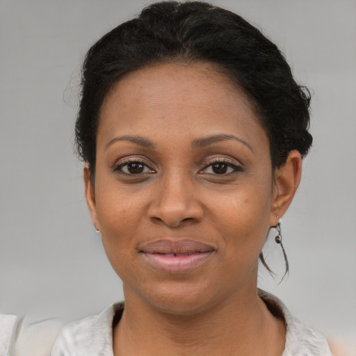 Joyful latino adult female with short  brown hair and brown eyes