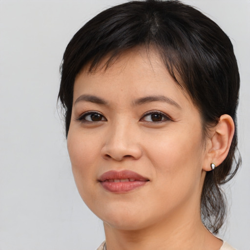 Joyful asian young-adult female with medium  brown hair and brown eyes