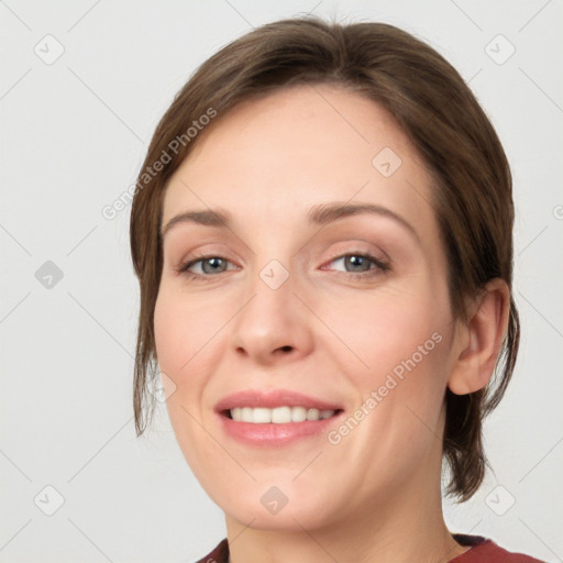 Joyful white young-adult female with medium  brown hair and grey eyes