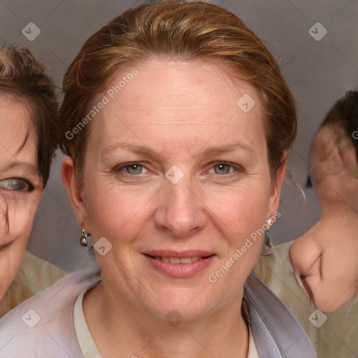 Joyful white adult female with medium  brown hair and blue eyes