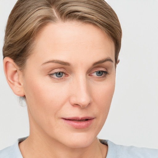 Joyful white young-adult female with short  brown hair and blue eyes