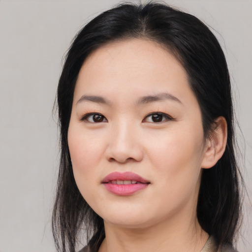 Joyful asian young-adult female with long  black hair and brown eyes