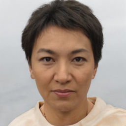 Joyful asian adult female with short  brown hair and brown eyes