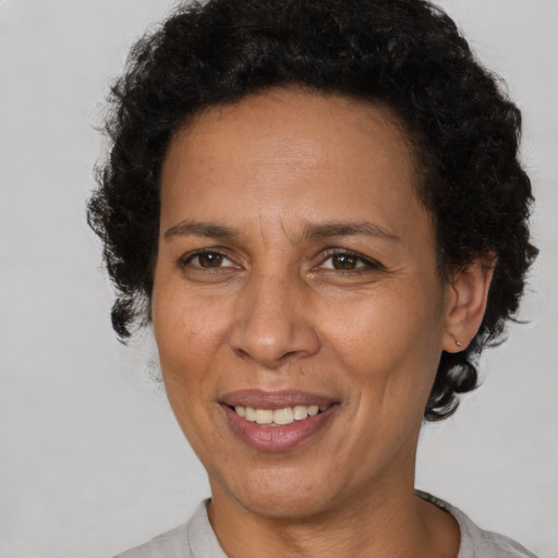 Joyful latino adult female with short  brown hair and brown eyes