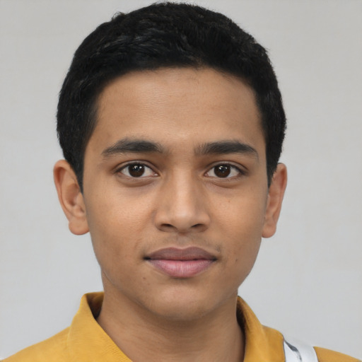 Joyful latino young-adult male with short  black hair and brown eyes