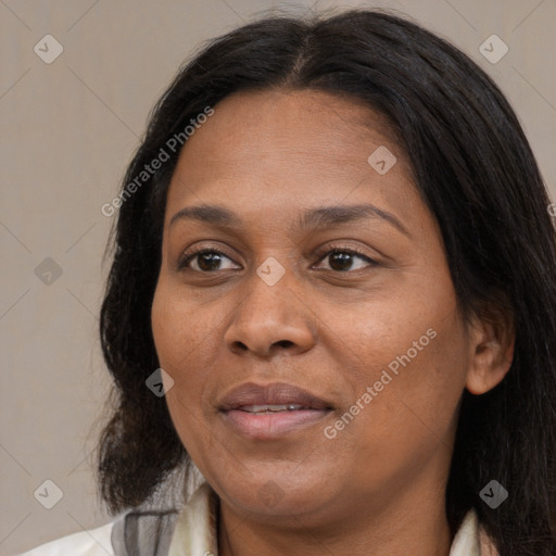 Joyful black adult female with long  brown hair and brown eyes