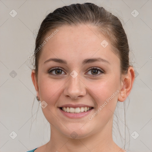 Joyful white young-adult female with medium  brown hair and grey eyes