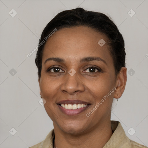 Joyful black young-adult female with short  brown hair and brown eyes