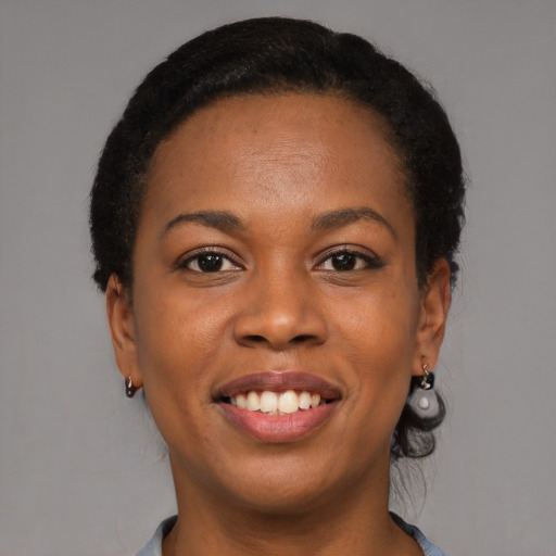 Joyful black young-adult female with medium  brown hair and brown eyes