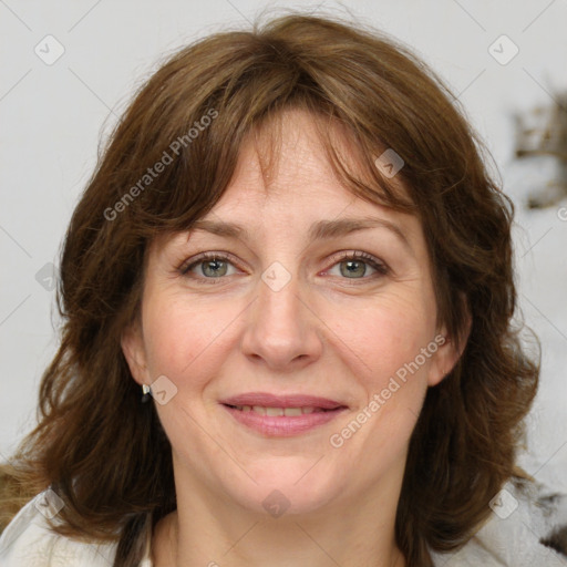 Joyful white adult female with medium  brown hair and green eyes