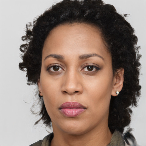 Joyful black young-adult female with medium  black hair and brown eyes