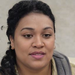 Joyful black young-adult female with long  brown hair and brown eyes