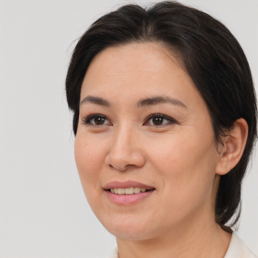 Joyful asian adult female with medium  brown hair and brown eyes