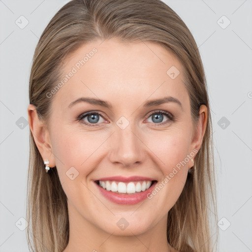 Joyful white young-adult female with long  brown hair and blue eyes