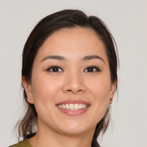 Joyful white young-adult female with medium  brown hair and brown eyes