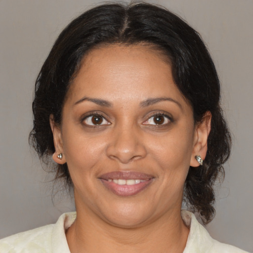 Joyful black adult female with medium  brown hair and brown eyes