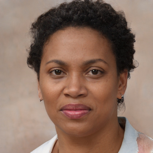 Joyful black adult female with short  brown hair and brown eyes