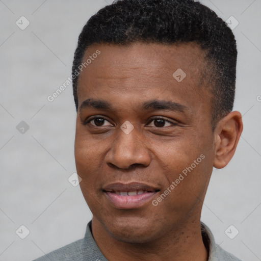 Joyful black young-adult male with short  black hair and brown eyes