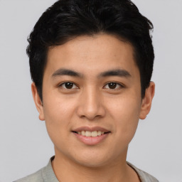 Joyful asian young-adult male with short  black hair and brown eyes