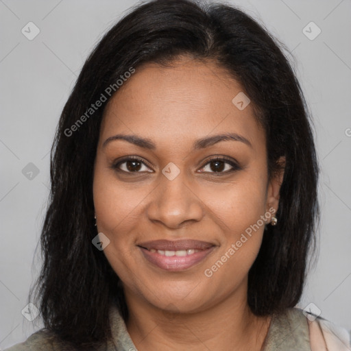 Joyful black young-adult female with long  brown hair and brown eyes