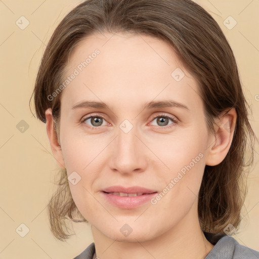 Joyful white young-adult female with medium  brown hair and grey eyes