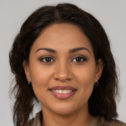 Joyful latino young-adult female with long  brown hair and brown eyes