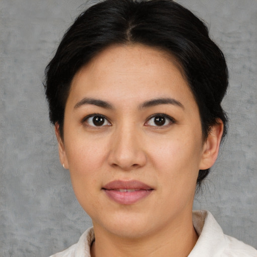 Joyful white young-adult female with short  black hair and brown eyes